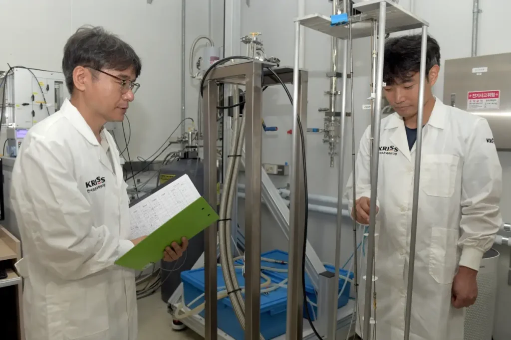 KRISS researchers inspect cryogenic experimental equipment used to measure the quantum transport properties of topological insulator nanowires.